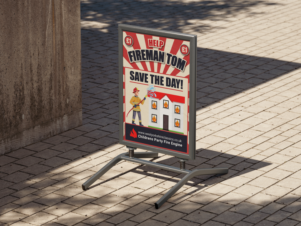Outdoor freestanding sign promoting a children's fire engine party game titled 'Help Fireman Tom Save the Day!' Features bold, colourful graphics and a firefighter character, showcasing playful event branding and custom printed signage for family-friendly attractions.